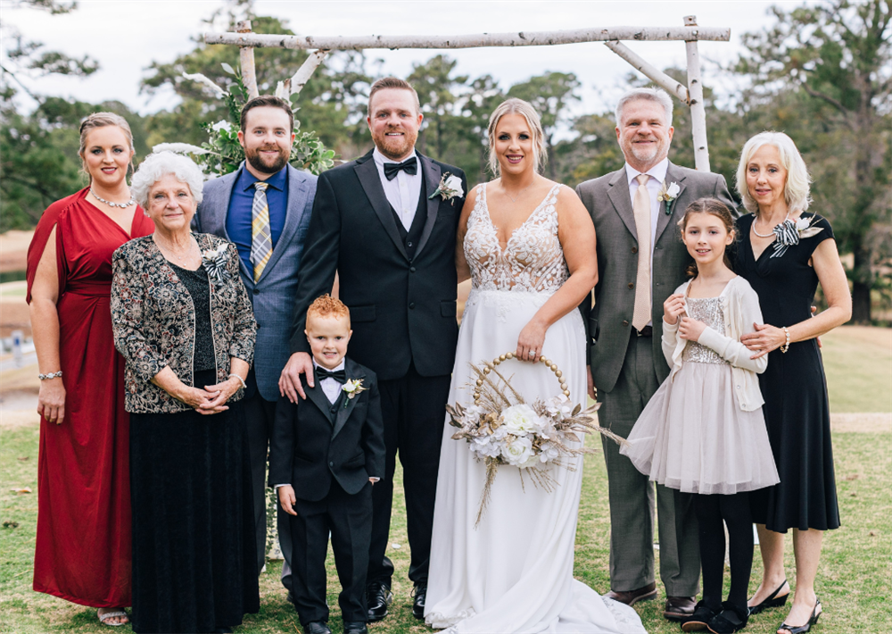 OEM Sales Manager Captain Mark Henderson with his family. From left to right, daughter Rachel, mother Sue, son Crockett, grandson Colby, son Joshua, daughter-in-law Madison, Mark, granddaughter Olivia, and wife Audrey.